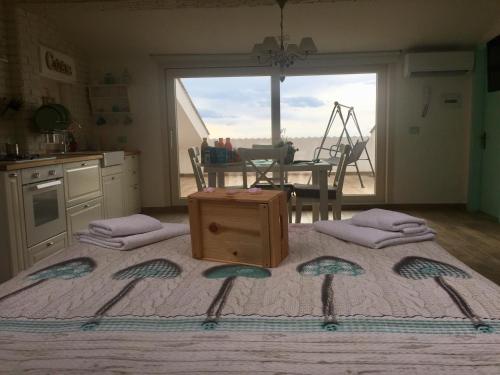a bedroom with a bed with a table and a window at Chic & Beauty in Agrigento