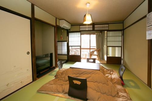 a room with a bed in the middle of it at Holy's House in Kyoto