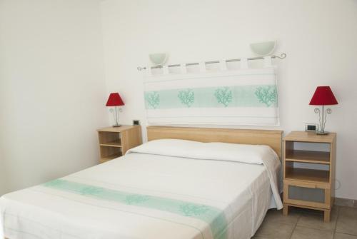 a bedroom with two beds and two lamps and a window at Casa ARCU DE CHELU in Santa Lucia