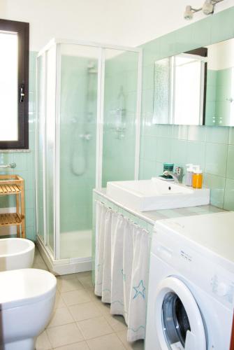 a bathroom with a washing machine and a shower at Casa ARCU DE CHELU in Santa Lucia