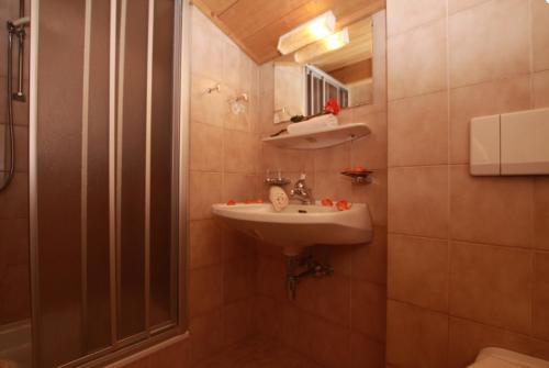 a bathroom with a sink and a shower at Klauserhof in Trins