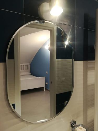 a bathroom mirror with a sink and a bed at Chalet sul mare in Catanzaro Lido