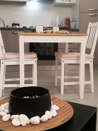 a kitchen with a table with a bowl on a table at Chalet sul mare in Catanzaro Lido