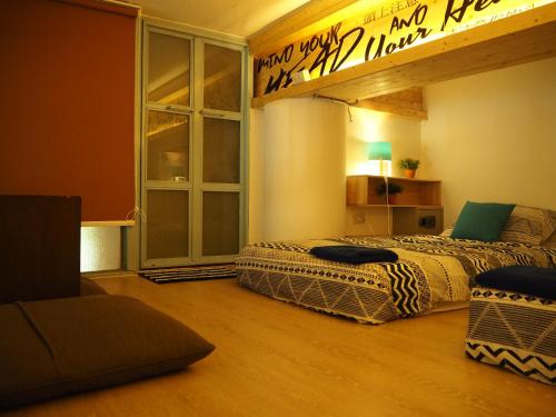 a bedroom with two beds in a room with a window at Blu Cabin Ari Stylish Gay Poshtel in Bangkok