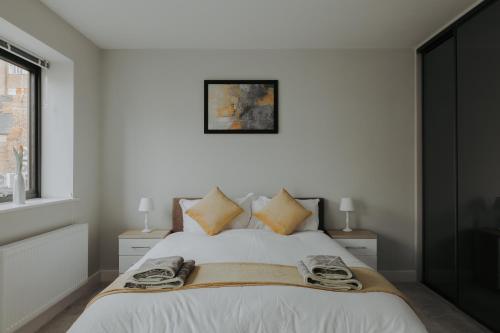 a bedroom with a bed with two lamps and a window at Weaver House in Chester