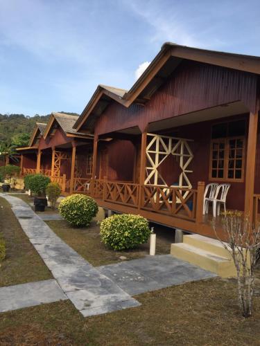 a large wooden house with a porch at Samudra Beach Chalet in Perhentian Island