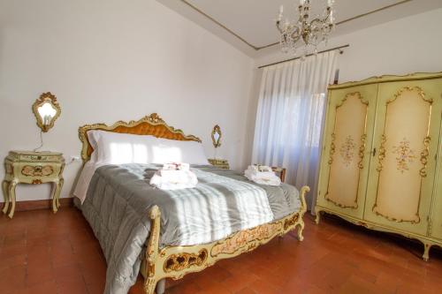 a bedroom with a bed and a chandelier at B&B PALAZZI in Florence