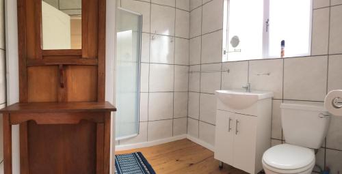 a bathroom with a toilet and a sink at David Bongers Still Bay Holiday Home in Stilbaai