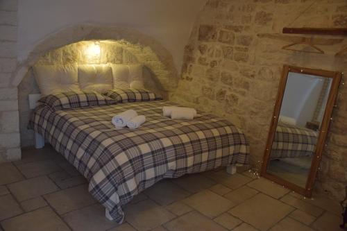 a bedroom with a bed with two towels on it at Dimora Levante in Ostuni