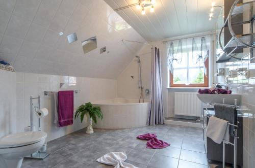 ein Badezimmer mit einer Badewanne, einem WC und einem Waschbecken in der Unterkunft Haus Sonnenschein in Gößweinstein