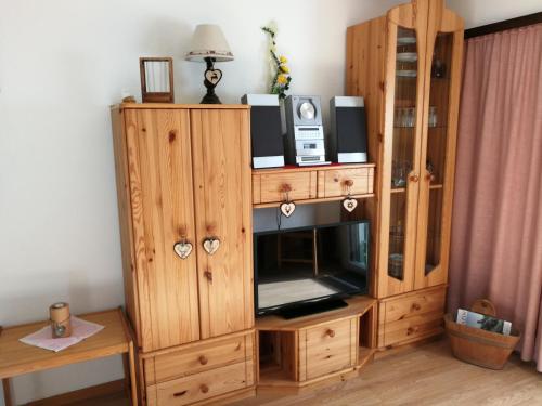 a wooden cabinet with a television in it at Haus Residence in Täsch