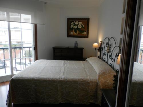 um quarto com uma cama e uma janela com vista em Silgar I em Sanxenxo