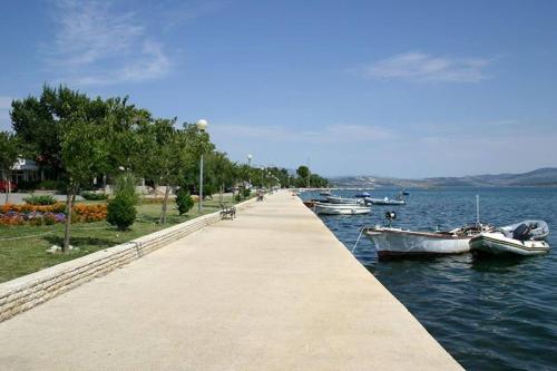a dock with boats in the water next to a lake at Apartmani Ante in Posedarje