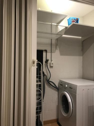 a washer and dryer in a small bathroom at Apartment im Emmental in Oberburg