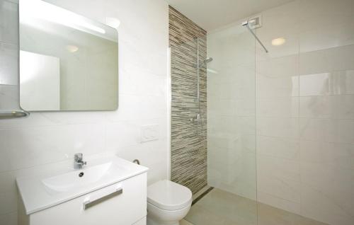 a bathroom with a toilet and a sink and a shower at Apartment MIVA in Brela