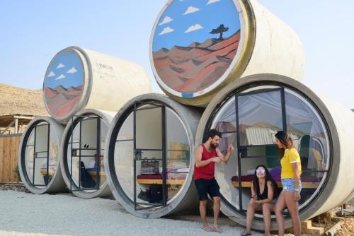 a group of people standing in front of a circular building at Tsavta in Mashabbe Sade