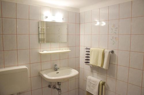 a bathroom with a sink and a mirror and towels at Gasthof Gruber in Wald am Schoberpaß