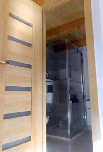 a glass door in a kitchen with wooden walls at Rychlebská Pohoda in Černá Voda