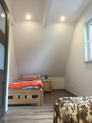 Postel nebo postele na pokoji v ubytování Dukatówka