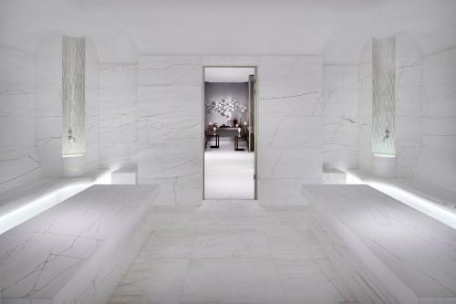 a white room with a hallway with a doorway at Address Downtown in Dubai