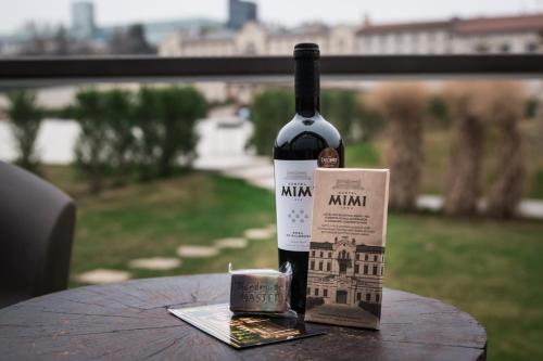a bottle of wine sitting on top of a table at Castel Mimi Wine Resort in Bulboaca