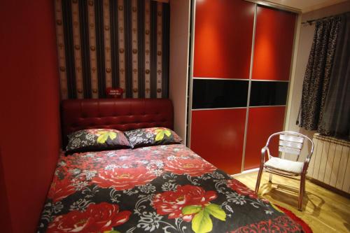 a bedroom with a bed and a chair at Kopernikus Apartments in Ulcinj