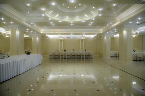 a large banquet hall with tables and chairs in it at Imperial Hotel IH in Elbasan