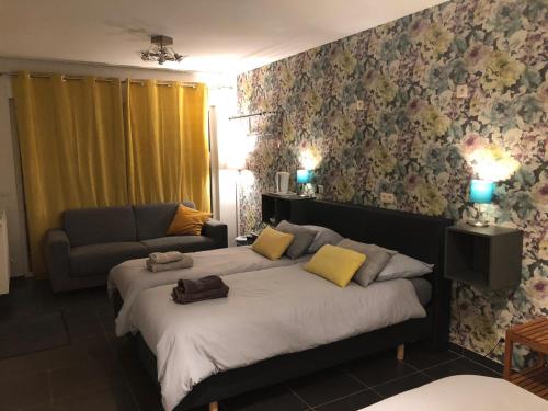 a bedroom with a large bed and a couch at Li Mangon in Francorchamps