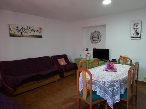 a living room with a table and a bed at Casas los Rosales in Guadix