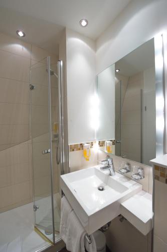 a bathroom with a sink and a shower at Best Western Hotel Kaiserhof in Bonn