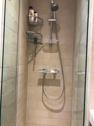 a shower with a hose in a bathroom at TosleepinCPH in Copenhagen