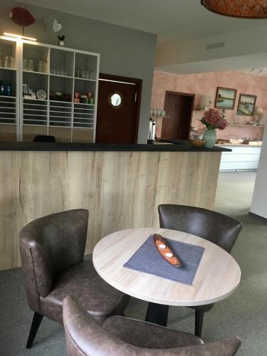 a table and two chairs and a counter at Landhaus am Schaalsee in Zarrentin