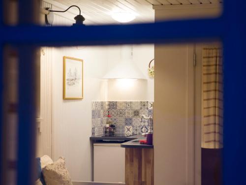 a small kitchen with a table and a lamp at Adami Country Guesthouse in Vainupea