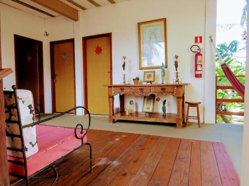 a living room with a fireplace and a table at Tribo de Gaia in Itaúnas