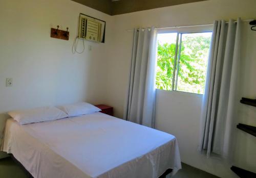 Giường trong phòng chung tại Tribo de Gaia