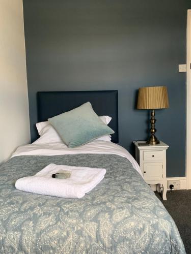 a bedroom with a bed with a white towel on it at The Nags Head - Room only accommodation in Lyme Regis