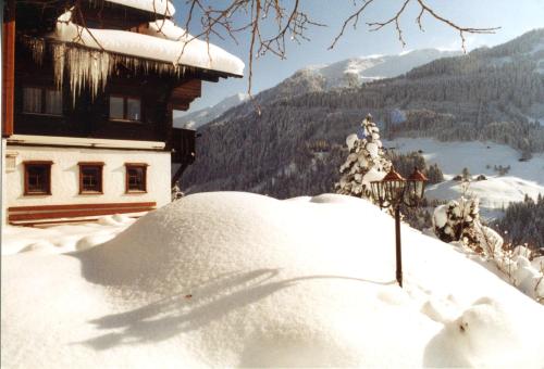 a pile of snow in front of a building at Gästehaus am Berg in Hirschegg