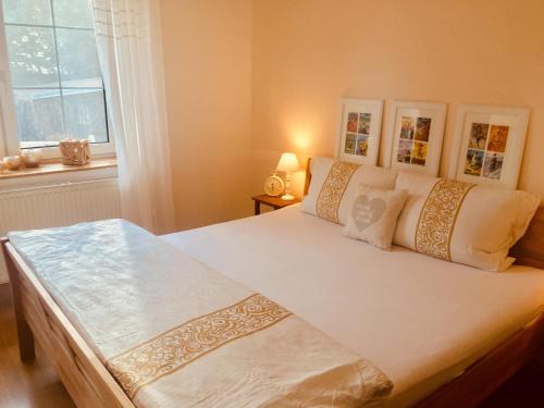 a large white bed in a room with a window at Vila EVIO Třeboň in Třeboň