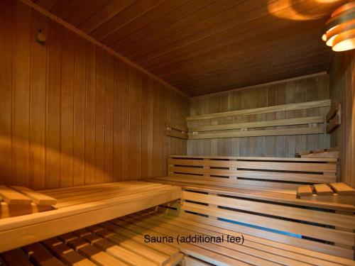 a wooden sauna with wooden benches in a room at Spectacular View & Central Location in Davos in Davos