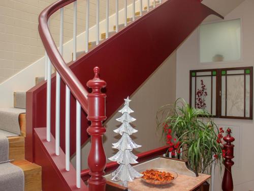 a staircase with a christmas tree on a table at Banho de Mar in Póvoa de Varzim