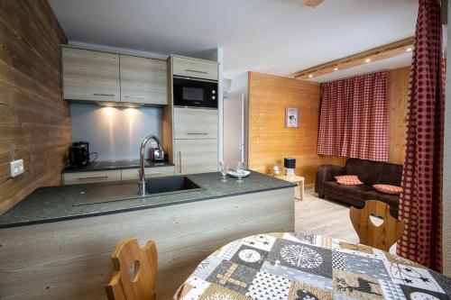 a kitchen with a sink and a counter top at Les Adrets in Gérardmer