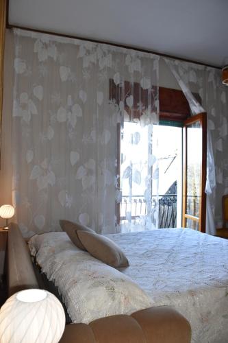 a bedroom with a large bed and a window at casa dei limoni in Massa Lubrense