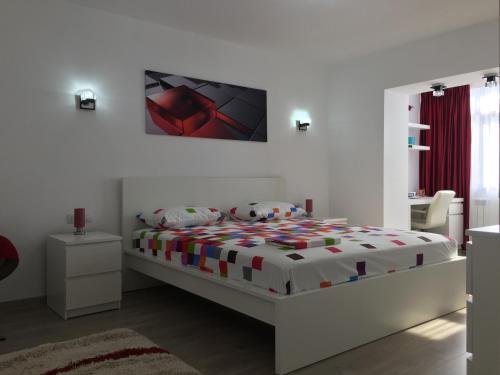 a bedroom with a bed and a tv on the wall at Luxury Apartment in Galaţi