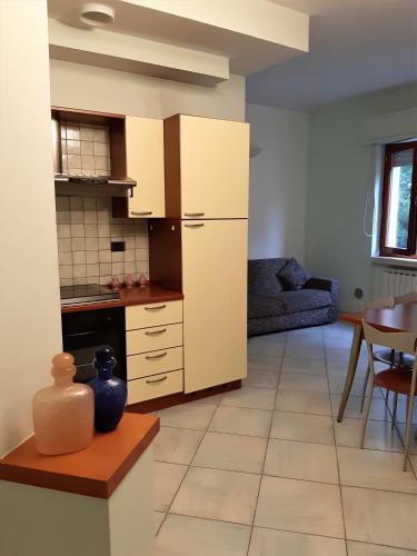 une cuisine avec des placards blancs et une table dans l'établissement Locanda Cuore di Mare - 2, à Vasto