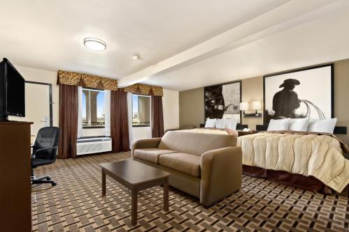 a hotel room with a bed and a chair at Super 8 by Wyndham Fort Worth TX in Fort Worth