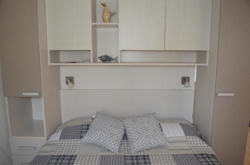 una camera da letto con armadi bianchi e un letto con due cuscini di Stella Maris Cottage With Garden a Bol