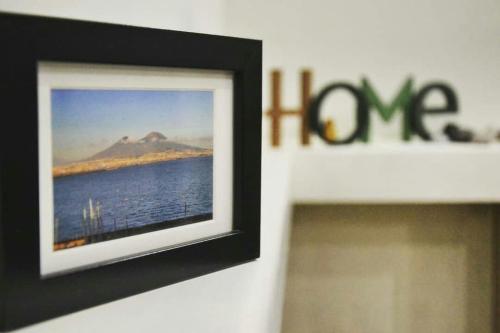 a picture hanging on a wall next to the water at Le Fontanelle B&B in Sarno