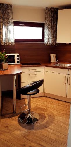 a kitchen with a stool in the middle of a kitchen at Central Hotel-Apart München in Munich