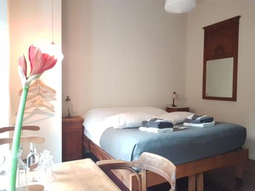 a bedroom with a bed with a table and a table sidx sidx sidx at SintAnna B&B PetitHotel in Yerseke