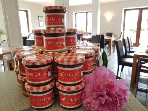 a stack of jars of master claus next to a flower at Residenz am Ostufer in Boek